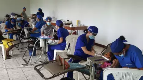 Photo of the pop-up operatory, with volunteers applying sealants