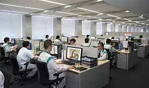 A photo of a room full of computers and machines demonstrating CAD-based mechanical design